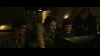 four men looking at computer monitor — The Social Network