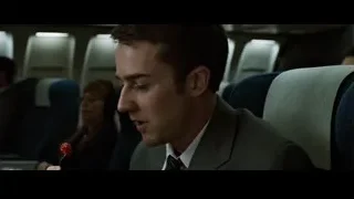 man in suit on airplane holding red button — Fight Club