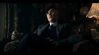 man holding cigarette in dimly lit living room — Peaky Blinders
