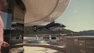 Man on yacht deck looking at helicopter — Succession