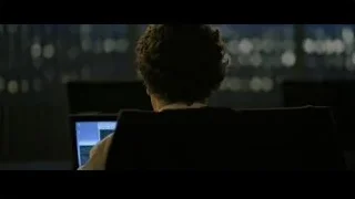 young man looking at laptop in dark room — The Social Network