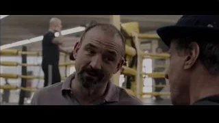 Two men conversing in a boxing ring — Creed
