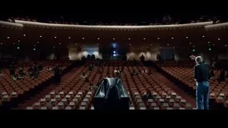people on stage in large auditorium — Steve Jobs