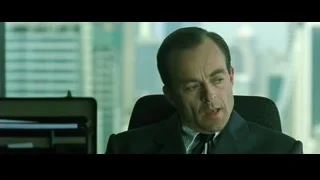 man in suit sitting in office — The Matrix