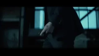 person in suit holding red flashlight — John Wick