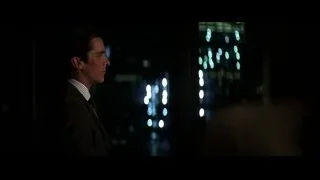 Man in suit looking out city window at night — Batman: The Dark Knight