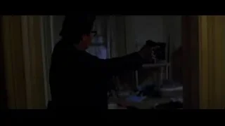 Person holding gun in dimly lit room — Batman: The Dark Knight