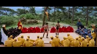 man in red robe performing with sword — Bruce Lee: Enter The Dragon