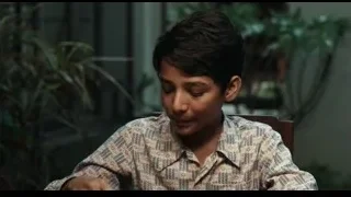 Young boy looking at laptop screen — Life of Pi