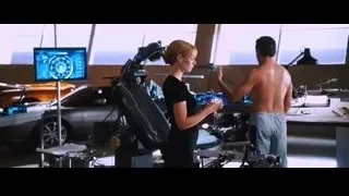 shirtless man and woman with futuristic screen — Iron Man