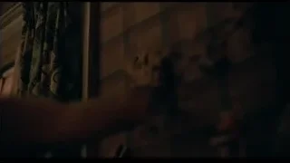 Shirtless person's back in dimly lit room — Joker