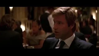 man in suit sitting at restaurant table — Batman: The Dark Knight