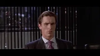 man in suit sitting in office chair — American Psycho