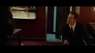 Man in suit and woman in red-walled room — Steve Jobs