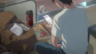 young man looking at phone in train station — Weathering with You