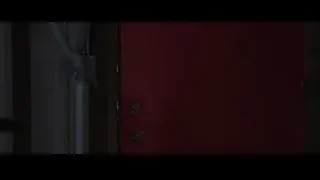 young boy standing in front of red door — Iron Man 3