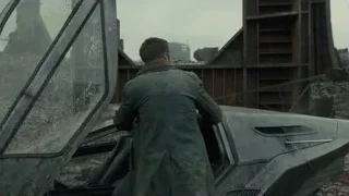 man by destroyed futuristic car with rubble — Blade Runner 2049
