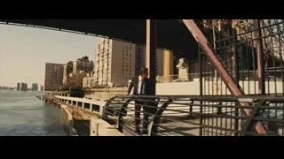 Two men walking on bridge with city skyline — Now You See Me