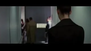 men in suits standing in hallway — Batman: The Dark Knight Rises