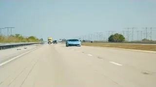 blue sports car driving on rural highway — Sports Cars