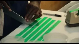 Person cutting paper with knife — The Bear