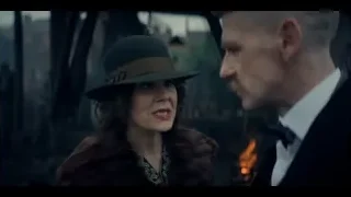 Man and woman in formal attire in dimly lit room — Peaky Blinders