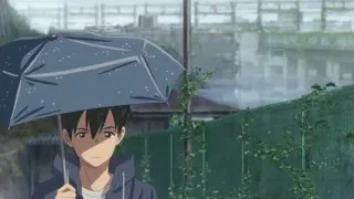 Young boy with blue umbrella by fence — Weathering with You