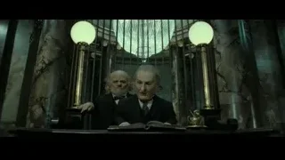 Two elderly men sitting at desk in dark room — Harry Potter and the Deathly Hallows 2