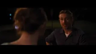 Man explaining to woman in dark setting — La La Land