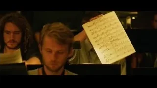 Musicians playing instruments in dimly lit room — Whiplash