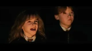 boy and girl in school uniform in dark room — Harry Potter and the Philosophers Stone