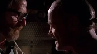 Two men facing each other in dimly lit room — Breaking Bad