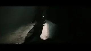 Bearded man standing with knife in dim room — Gladiator 2