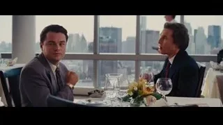 two men in suits at restaurant table — The Wolf Of Wall Street