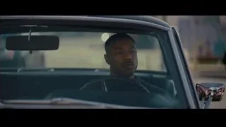 man sitting in car looking out window — Creed 2