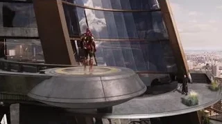 Iron Man on futuristic building overlooking city — The Avengers