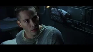 young man sitting on bed in dark room — The Matrix