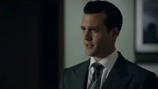 man in suit standing in dimly lit room — Suits