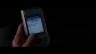 Person holding Nokia phone reading text message — Batman: The Dark Knight