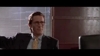 man in suit sitting in office — American Psycho