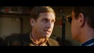 Two men talking in a garage — Ford v Ferrari