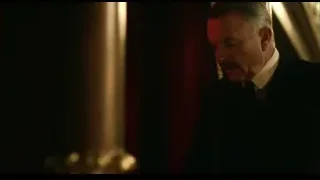 man in dark room with red curtain — Peaky Blinders