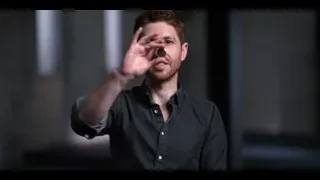 Young man with beard making peace sign — The Social Dilemma