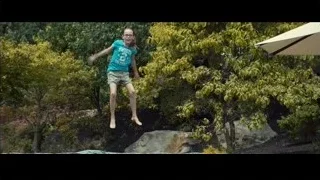 young girl jumping on trampoline in garden — Southpaw
