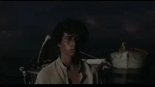 Young man with gun in dark room with boat — Life of Pi