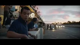 Man watching race cars at sunset — Ford v Ferrari