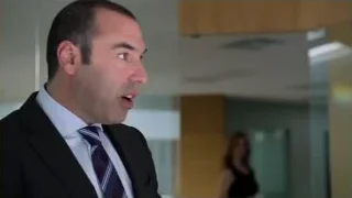 man in suit standing in office — Suits