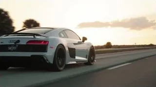 white sports car driving on highway at sunset — Sports Cars