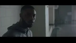 Man preparing meal in kitchen with city view — Creed 2