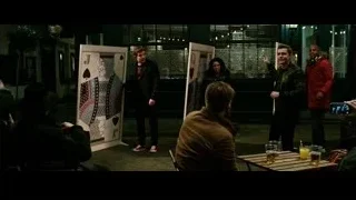 people in dimly lit room with card posters — Now You See Me 2